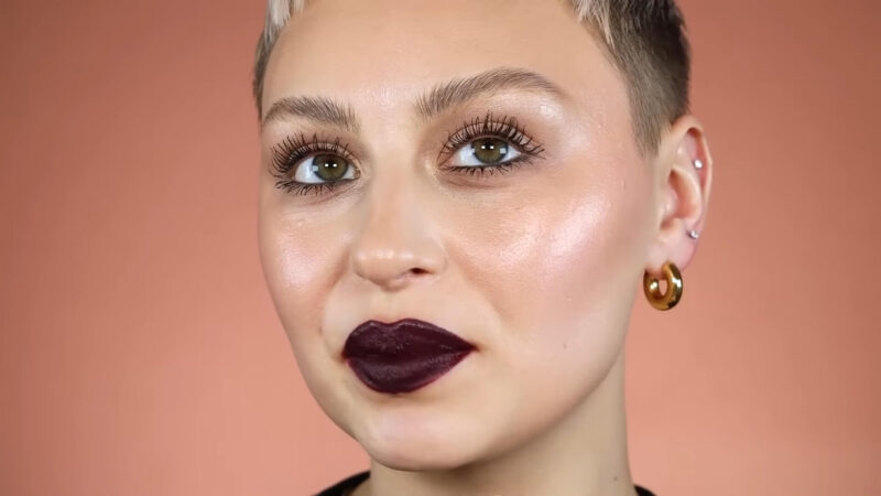 A woman with makeup highlighting her lips in bold colors